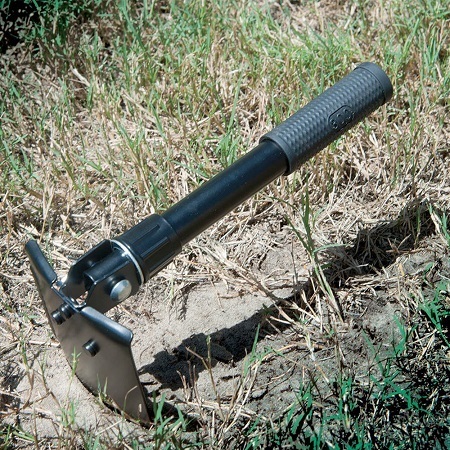 Multipurpose Survival Folding Shovel Digged in Dirt